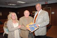 Dorene Smolens presents Township Historian John Parker and Mayor Gary Quinn the State Flag which was flown on the fantail of the USS Missouri in tribute to American veterans of all branches of service.